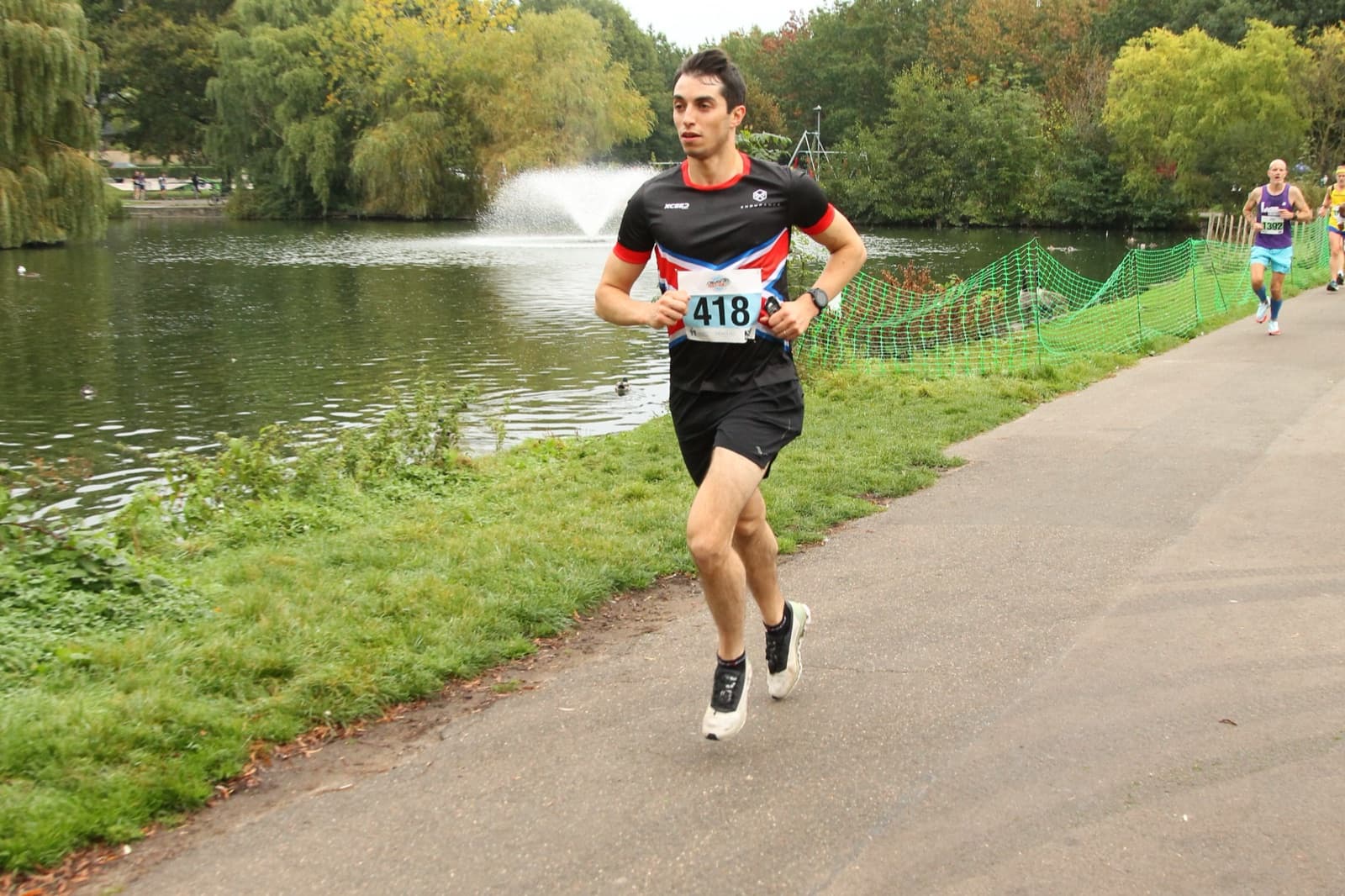 James running a race along a lakeside path